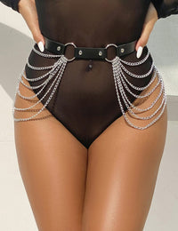a woman in a black bodysuit with chains around her waist