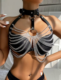 a woman wearing a black bra with chains on it