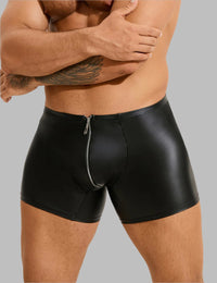 a man in black leather shorts with his arms crossed