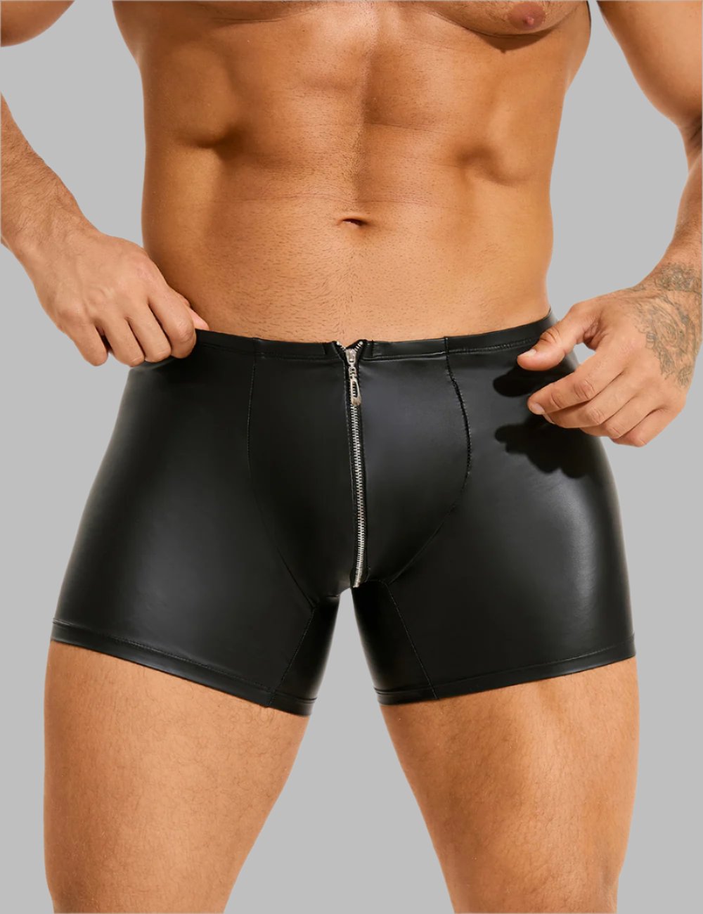 a man wearing a black leather shorts