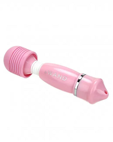 a pink hair dryer sitting on top of a white table