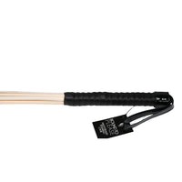 Bound to Please Multi-Strand Spanking Cane in an elegant setting, perfect for enhancing intimacy and pleasure.