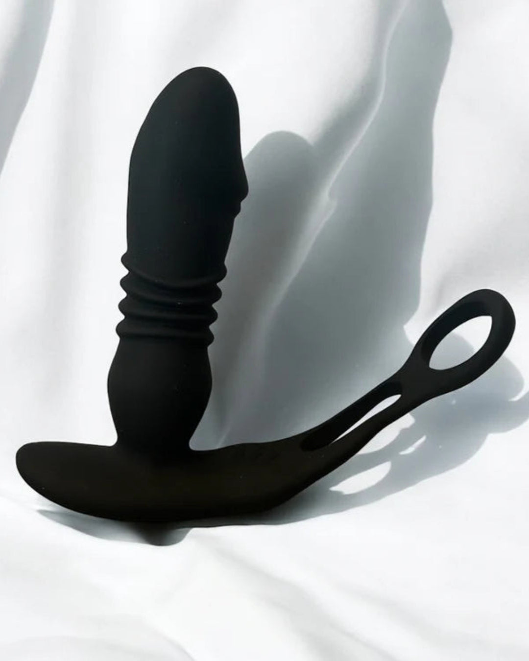 prostate massager sitting on top of a white sheet