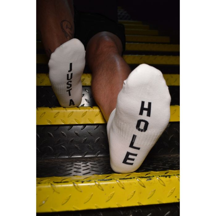 Model showcasing Prowler RED Ankle Sock Just A Hole, featuring tattooed legs on stairs, capturing a dynamic lifestyle vibe.