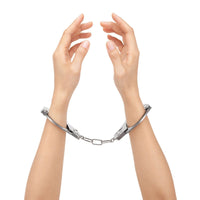a woman's hands are chained to a chain
