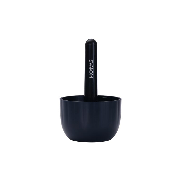 a black cup with a pen in it