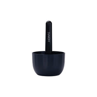 a black cup with a pen in it