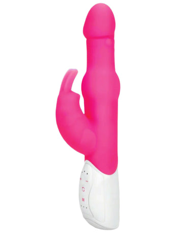 a pink and white rabbit vibrator is sitting on a gray surface