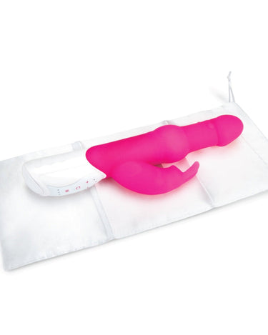a pink rabbit vibrator sitting on top of a white bag