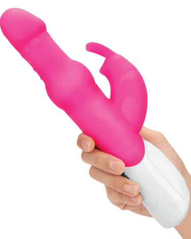 a person holding a pink rabbti vibrator in their hand