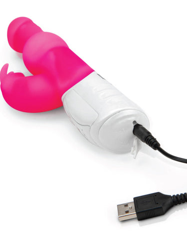 a pink and white rabbit vibrator connected to a black usb charger on a white background