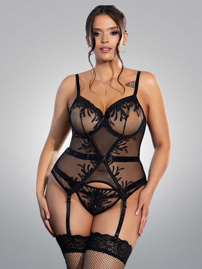 A woman wearing black lace lingerie, exuding confidence and allure. Available at Scandals, your destination for sensual attire and intimate accessories.