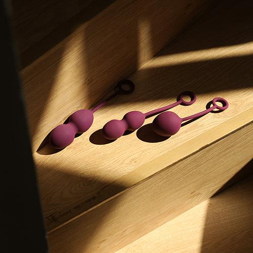 a pair of scissors sitting on top of a wooden table