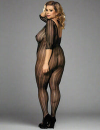 a woman posing with her back to the camera and her head over her shoulder, wearing the lace black stripe bodystocking by scandals in front of a grey studio background