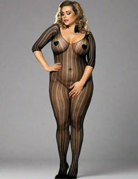 a curvy woman posing in scandals black lace stripe bodystocking in front of a grey studio background