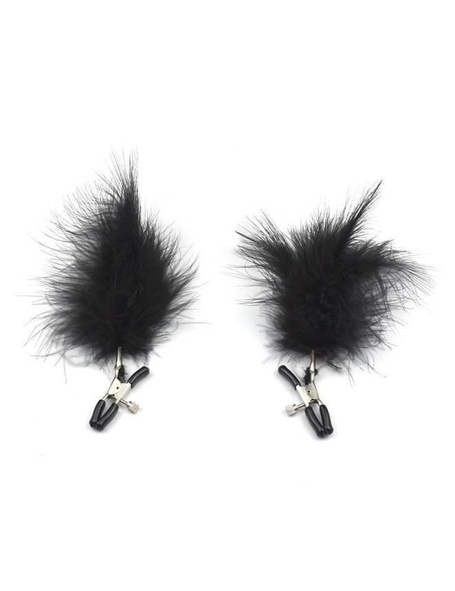 a pair of black feathers on a white background