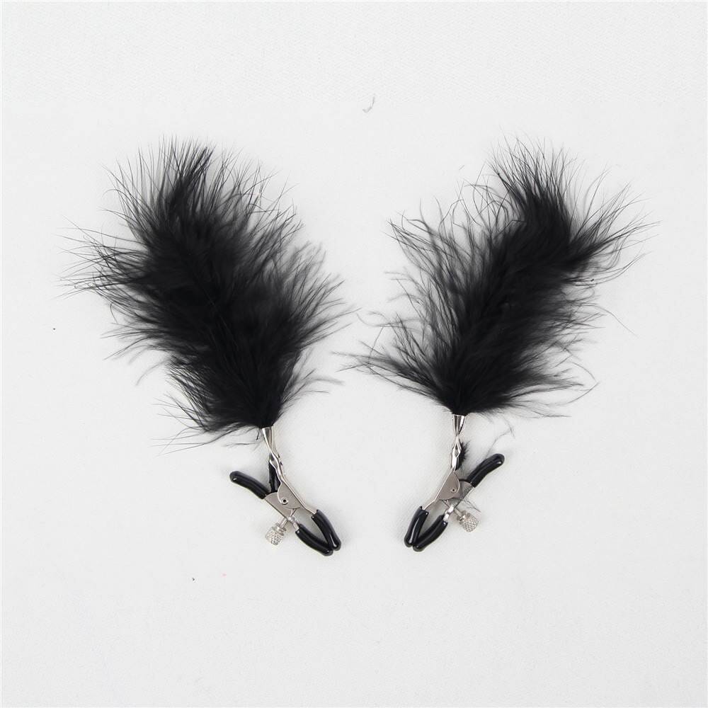 a pair of black feathers on a white background