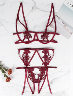 a pair of red lace garters sitting on top of a table