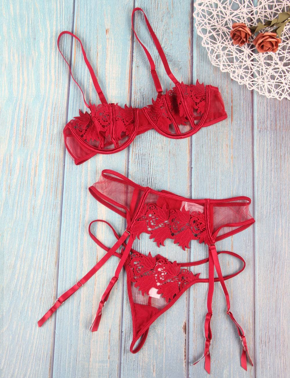 a pair of red lingerie on a wooden floor