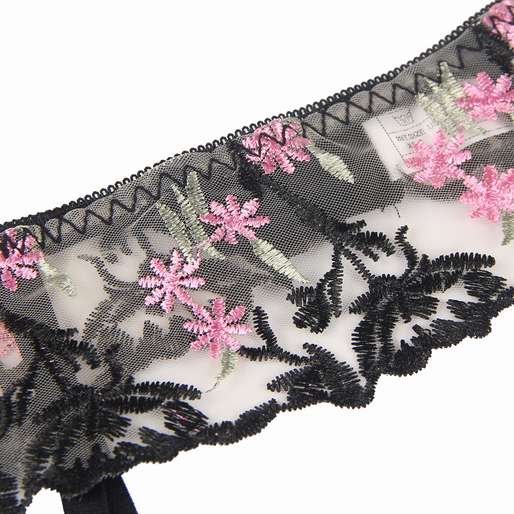a black and white lace with pink flowers on it