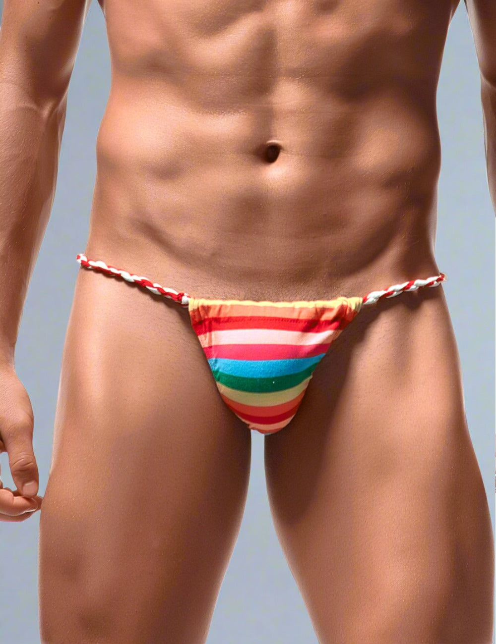 Men's rainbow thong with colorful striped design by Scandals Menswear, showcasing the vibrant waistband and sleek fit.