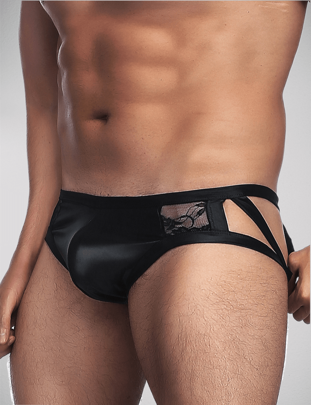 Scandals Menswear men's lace and wetlook briefs, black and shiny fabric, close-up view of the stylish, form-fitting underwear.