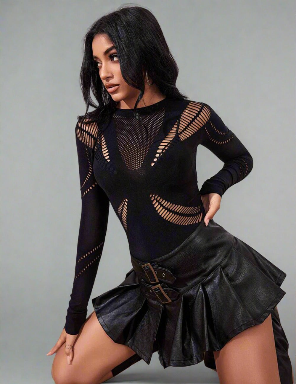 a woman posing in a black top and skirt