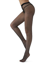 a side view of a woman in a black thong and black fishnet stockings with one leg bend seductively