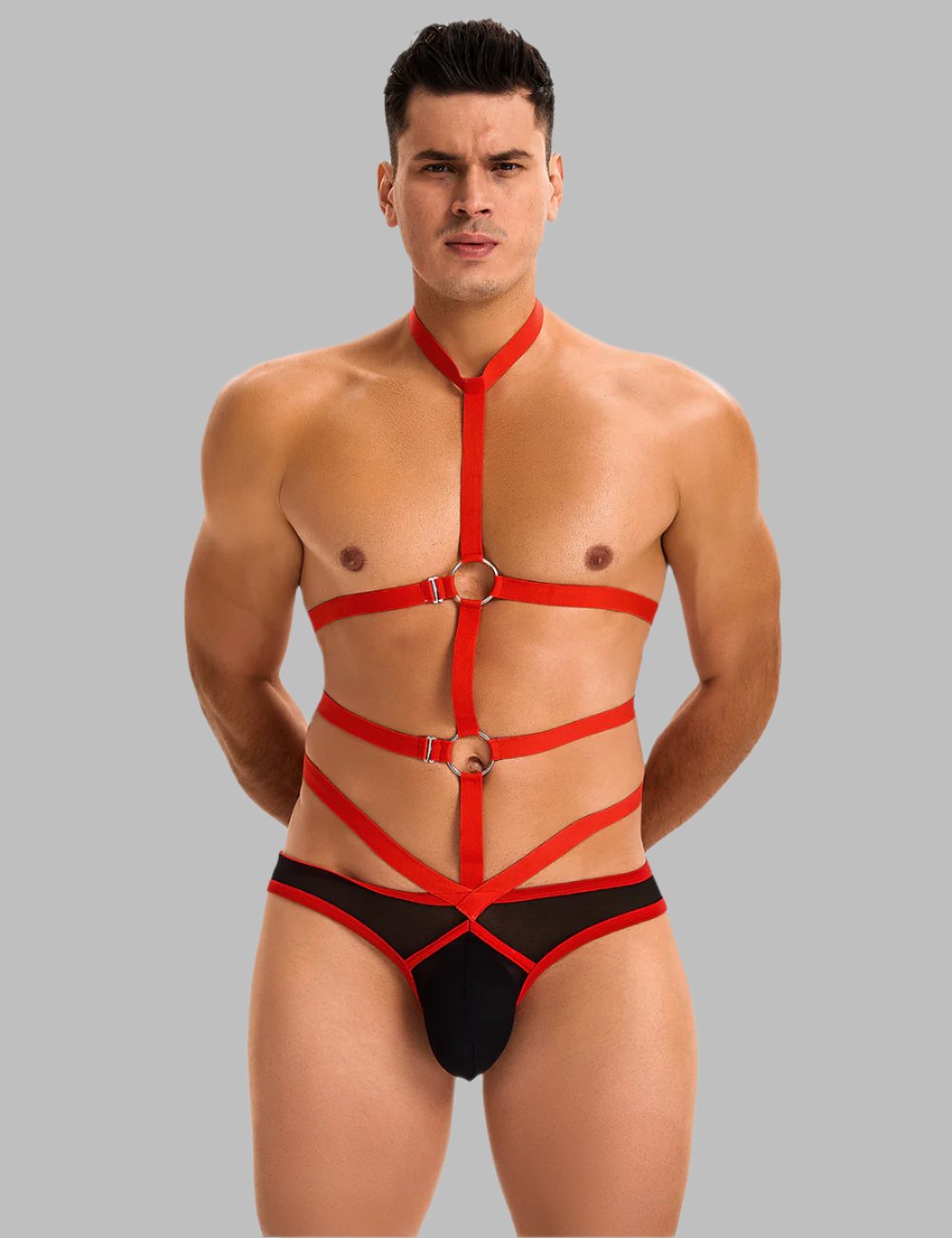 Men's bondage-inspired harness bodysuit by Scandals Menswear, featuring black straps and adjustable fit for a bold costume look.