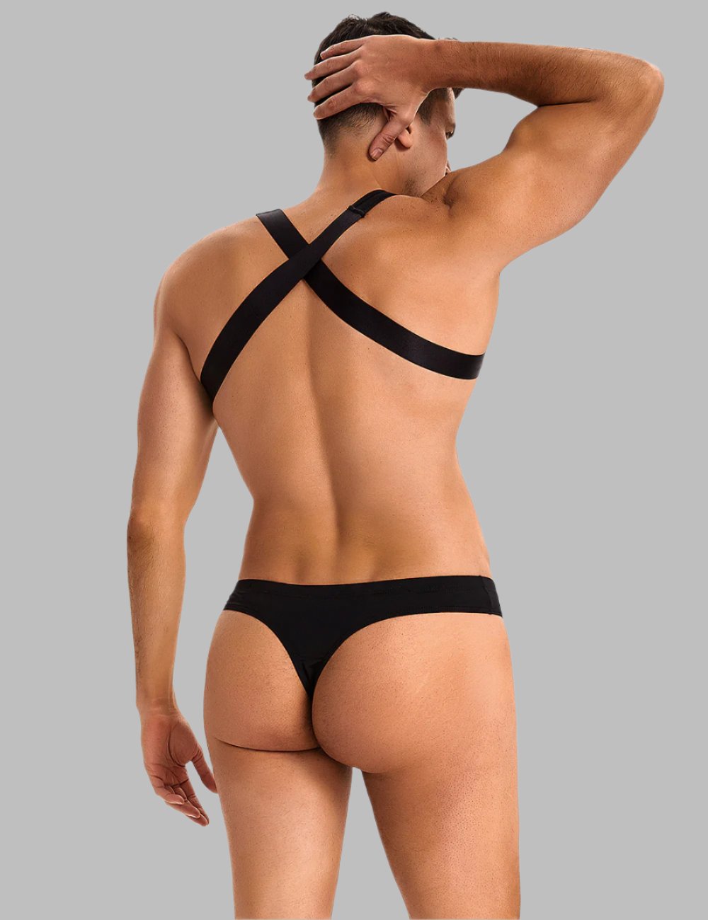 a man in a black thong with his back to the camera