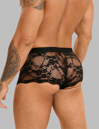 a man with a tattoo on his arm wearing a black underwear