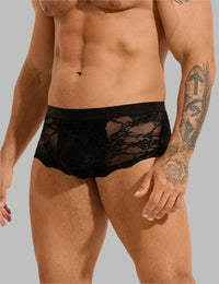 a man with a tattoo on his arm wearing a black underwear