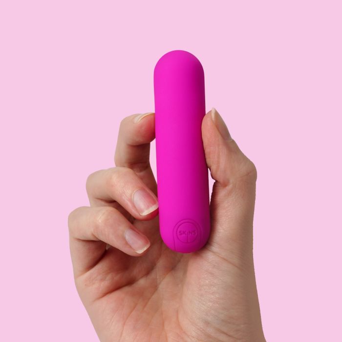 a person holding a pink object in their hand