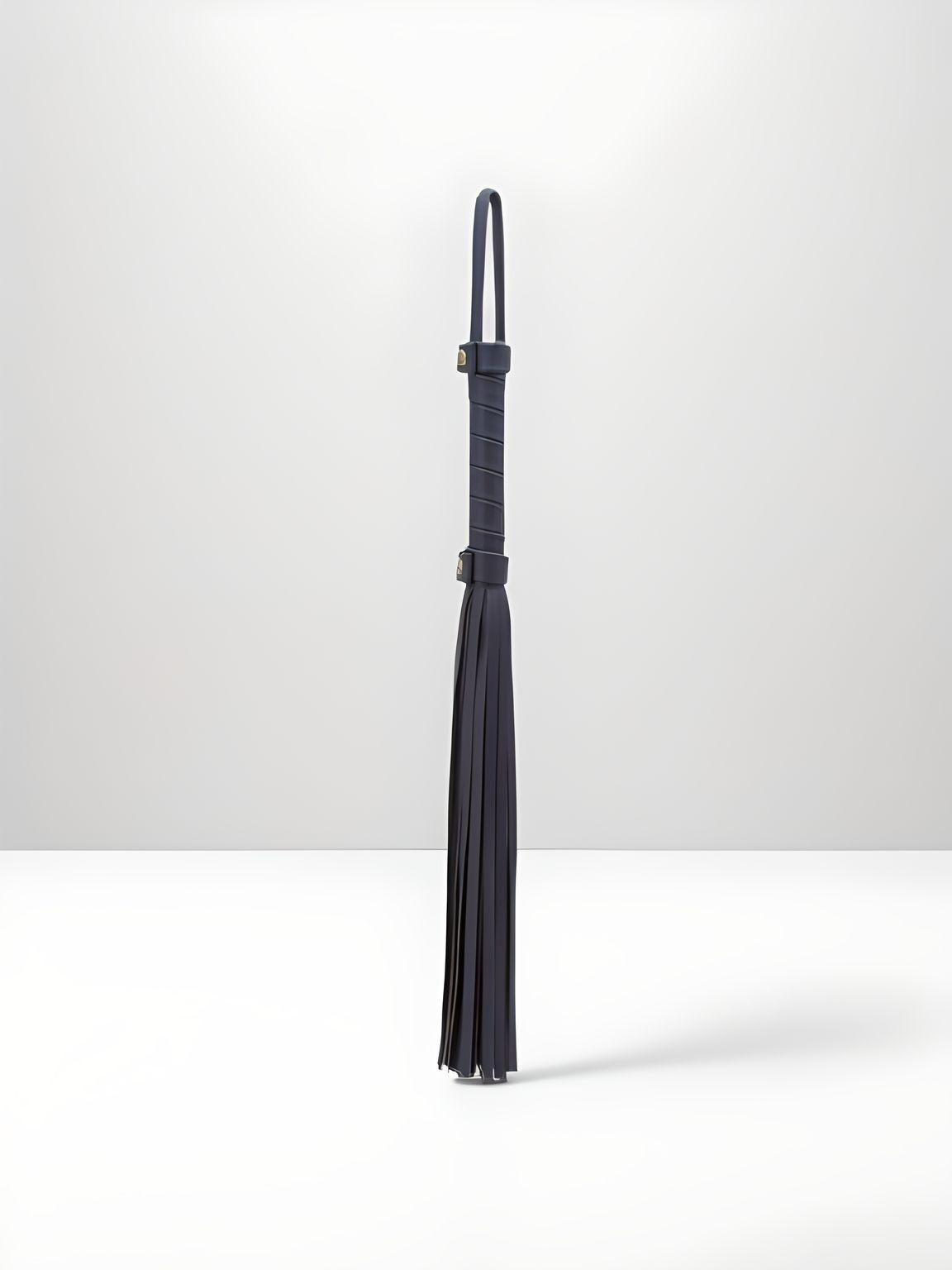 Elegant view of the Faux Leather Soft Flogger Bondage Couture by NS Novelties, featuring a sleek design with soft strands, ideal for superior pleasure in BDSM.