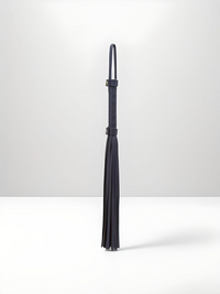 Elegant view of the Faux Leather Soft Flogger Bondage Couture by NS Novelties, featuring a sleek design with soft strands, ideal for superior pleasure in BDSM.
