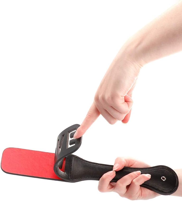 Hand elegantly holding a stylish paddle with a vibrant red underside, demonstrating its versatile design and luxurious appeal.