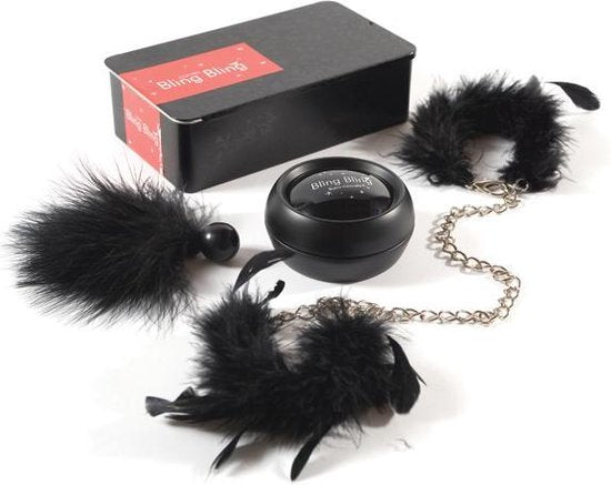 a couple of furry balls and chains on a white surface