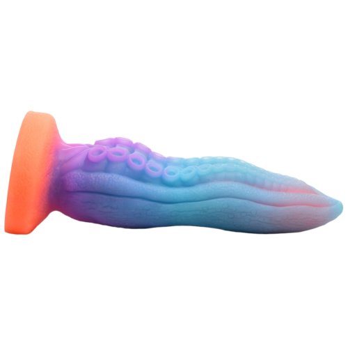 a blue and purple tentacle dildo stuck horizontally to a surface with an orange suction base by creature cocks 