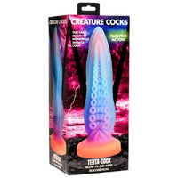 a blue and purple tentacle dildo with an orange base inside the box by creature cocks 