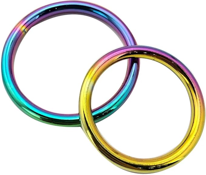 Two exquisite chrome metal cock rings, one larger and one smaller, gleaming with a vibrant rainbow finish that adds elegance to intimate moments.