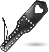 Elegant heart cut-out paddle made of high-quality leather, featuring a series of decorative rivets and a stylish design, perfect for luxurious experiences.