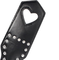 Stylish paddle featuring a heart-shaped cut-out and shimmering rivets, made from premium leather, ideal for enhancing intimate moments with a touch of elegance.