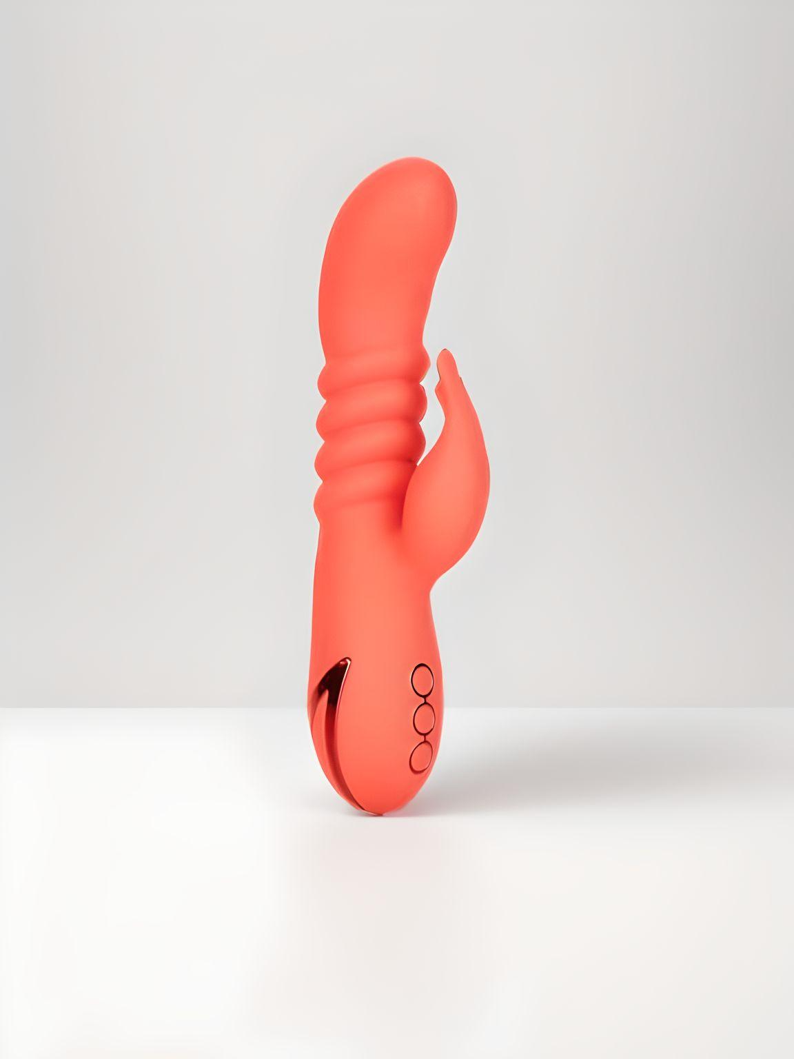 Elegant Orange County Cutie Thrusting Silicone Rabbit Vibrator showcasing its ergonomic design and vibrant colour, perfect for luxurious pleasure.
