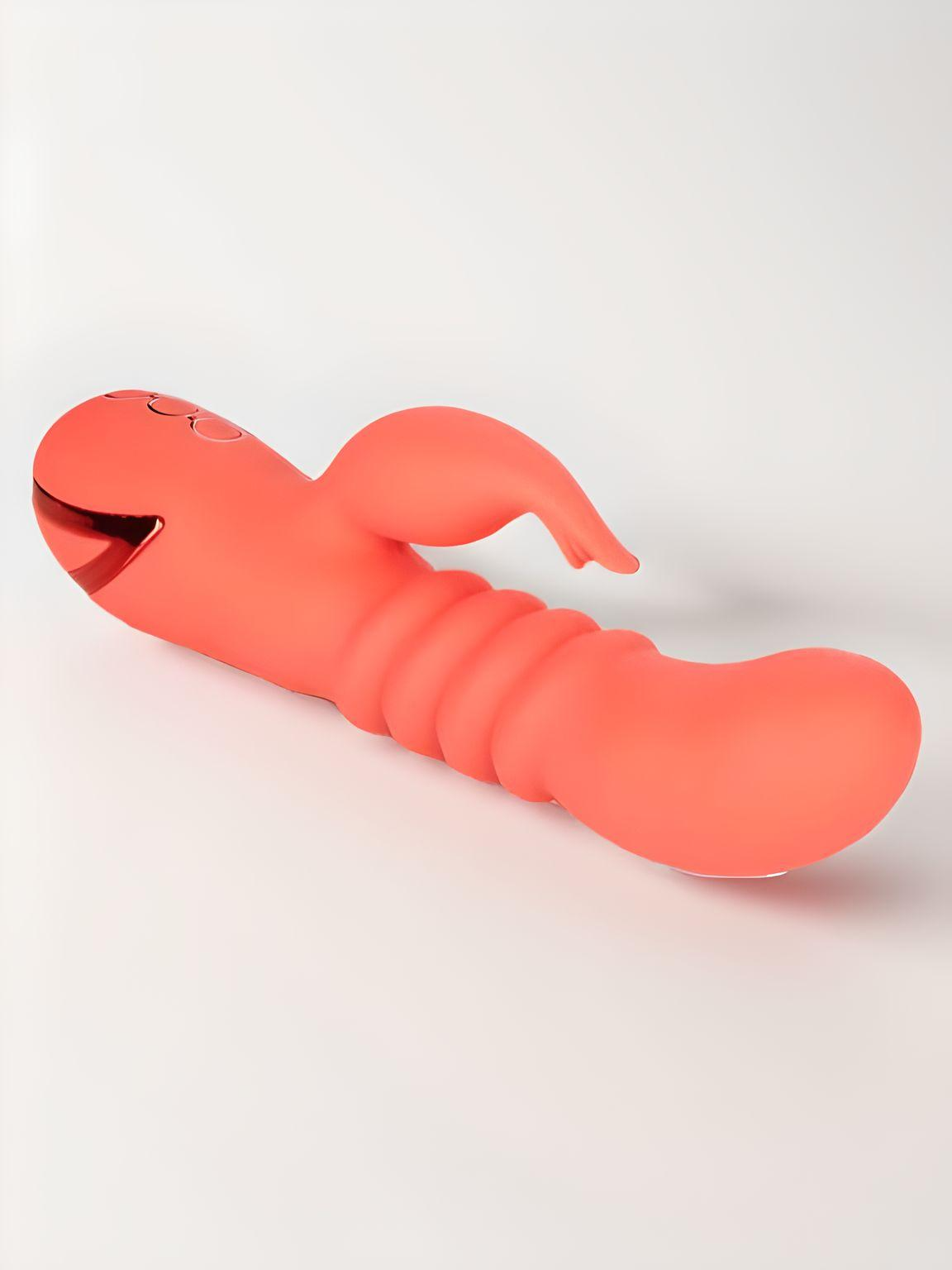 Stylish view of the Orange County Cutie Thrusting Silicone Rabbit Vibrator laid flat, highlighting its functionality and luxurious aesthetic.