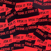 Thumbnail for a pile of red and black stickers that say risk it or drink it