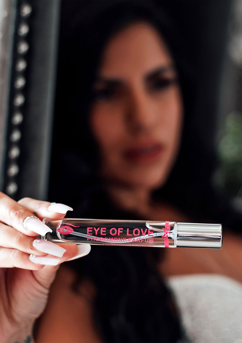 a woman holding a tube of eye of love