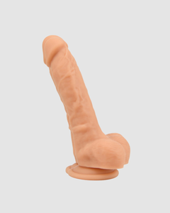 Loving Joy Realistic Silicone Dildo with Suction Cup and Balls showcased in a modern intimate space.