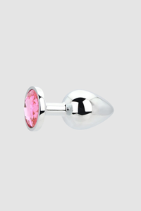 Toosh Butt Plug With Gems nestled amongst luxury items, accentuating its role as both a pleasure device and decorative piece.