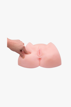 Pink silicone butt-shaped product held by a hand on a white background