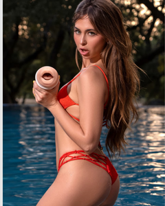 Fleshlight Girls Riley Reid Insomnia Blow Job Masturbator surrounded by lush textures, exemplifying the premium experience it offers to discerning users.